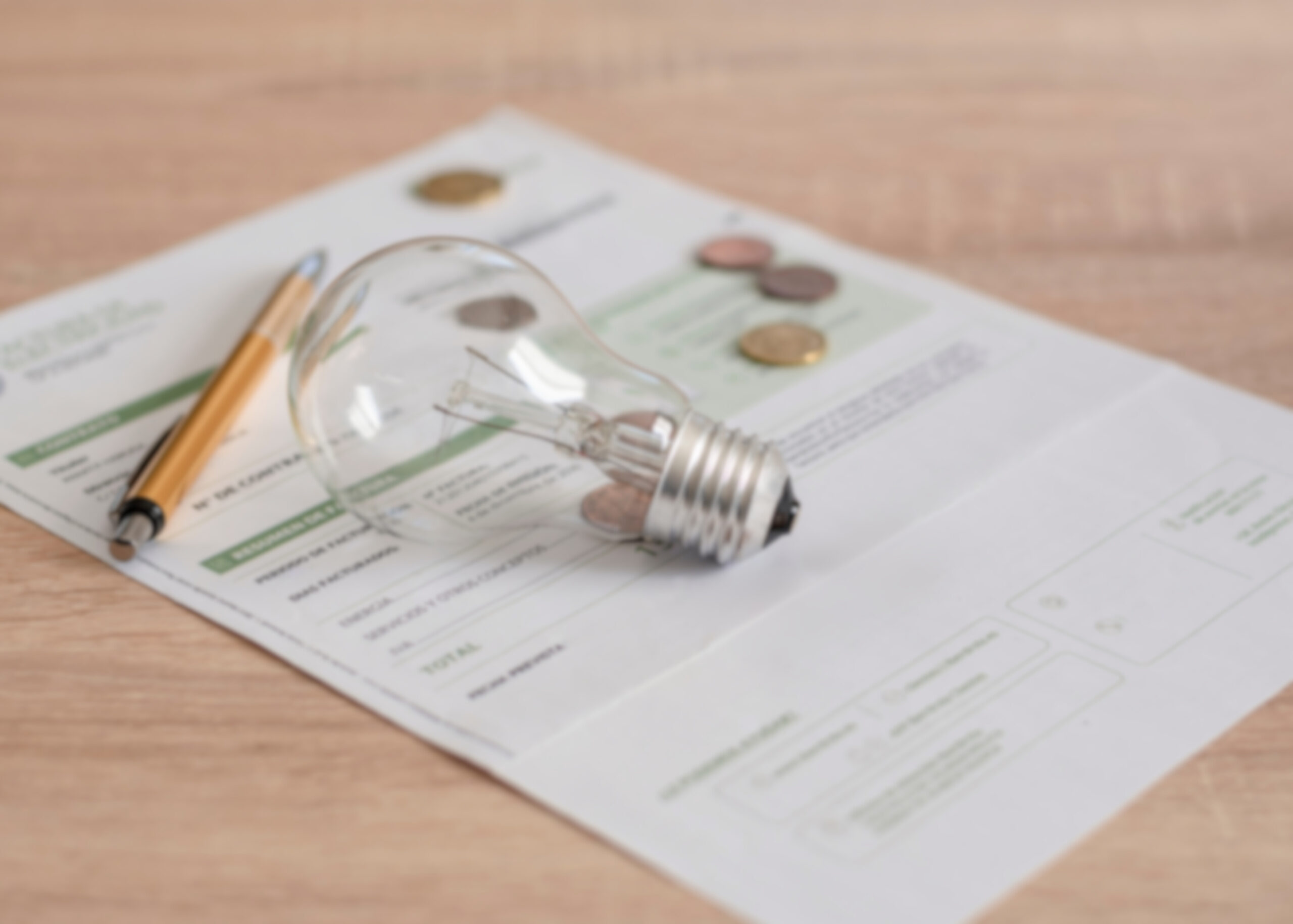 electricity bill with a lightbulb and pen on top